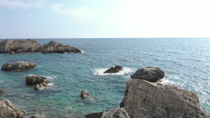 Sea waves roll against coastal cliffs