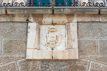 Catholic coat of arms on the wall of the monastery located on the territory of thecatholic Christian Transfiguration Church located on Mount Tavor near Nazareth in Israel