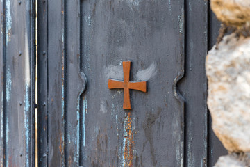 Metal gates decorated with a cross in the catholic Christian Transfiguration Church located on...