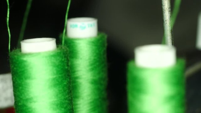 Spool of thread on overlock sewing machine macro shot