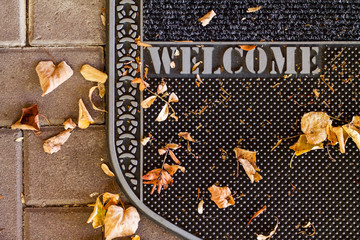 Welcome Autumn dirt trapper door mat with brown Autumn leaves