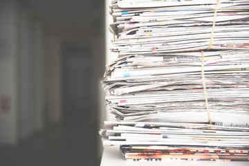 Pile of newspaper, background texture. Lots of retro journals with headlines, articles and photos