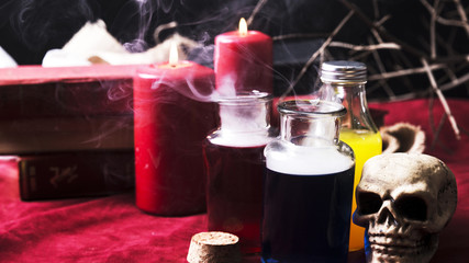 Opened bottles with potions and Halloween decorations