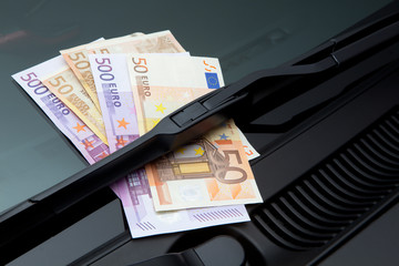 Euros under windshield wiper