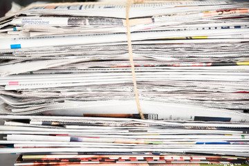 Pile of newspaper, background texture. Lots of retro journals with headlines, articles and photos
