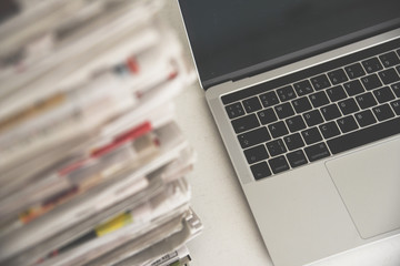 Newspapers and laptop