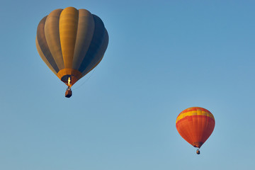 Two balloons soaring into the sky.