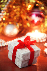 christmas gift box with red bow and candles with new year decor