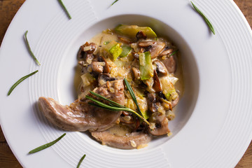 Lamb tongues with stewed vegetables and cream sauce. View from above, top studio shot