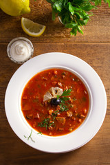Traditional Russian dish  solyanka - thick, spicy and sour saltwort soup.  View from above, top studio shot