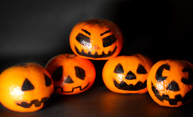 Halloween pumpkin Jack head on a black background. The traditional festival of autumn. Creepy heads. Selective focus.