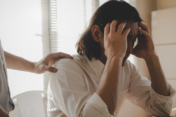 Comforting. asian business man upset about life problems with support from his best friend and sitting in home office, encouragement, fired from job, business problem, financial and investment concept