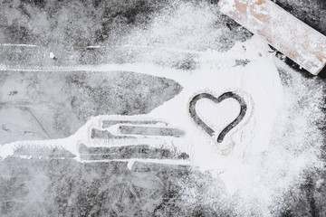 Baking background. Heart of flour and rolling pin on gray table. Bake menu, recipe, homemade pastry concept. Top view. Banner with copy space for your text. Valentine's Day