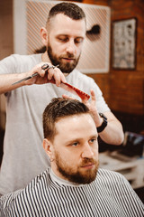Fototapeta premium Hipster client getting a haircut at barber shop