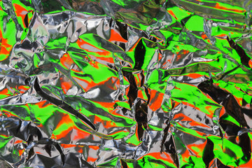 Crumpled foil colorful backdrop. Abstract background.