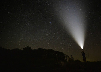 Beam of light in the starry night sky