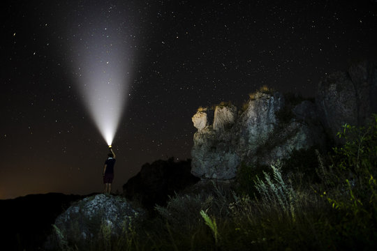 Person with a flashlight in the nature
