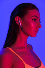 Image of seductive sensual woman wearing bodysuit underwear listening to music with earpods