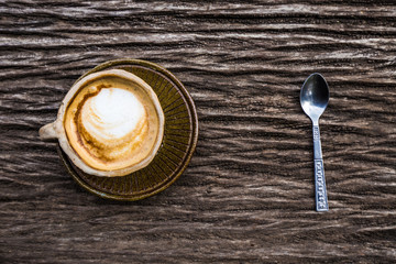 Hot latte art coffee serve on art wood table