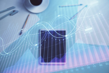 Double exposure of forex graph on digital tablet laying on table background. Concept of market analysis