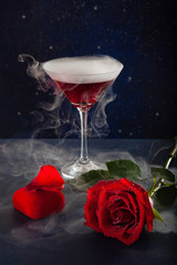 Midnight glass of mistic drink, rose and box with a ring