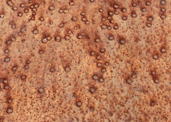 The spotty rusty metal background. Close-up