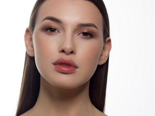 Fototapeta premium Close-up portrait of a beauty woman with full lips, straight hair and perfectly clean skin. Daytime makeup, styling and soft care. Skin care in the spa salon or cosmetology, smooth eyebrows