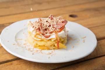 Spanish tapa, potato, fried egg, bacon and foie