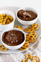 Healthy snack of homemade raw chocolate brownie dessert hummus made with chickpeas,cacao and...