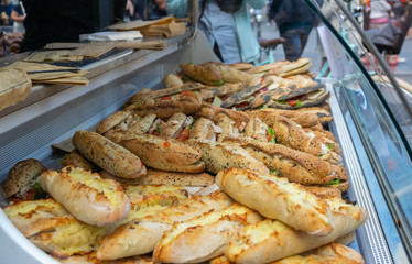 Traditional French dinner sandwiches in a large glacier with glass-case at a street market.