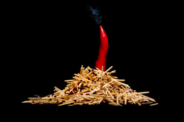 Folded on a black background in the form of a bonfire matches underscore the pungency of the red...