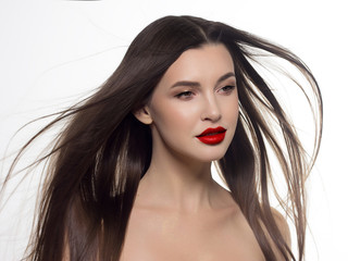 Fototapeta premium Close-up portrait of sexy european young woman model with classic glamour make-up and nude lipstick. Dark long hairstyle, christmas makeup, dark eyeshadows, natural red lips with gloss