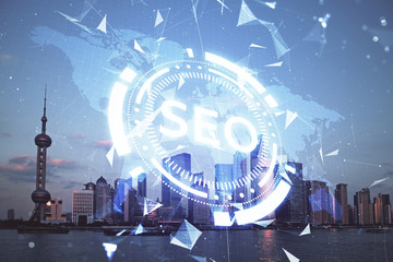 SEO hologram on city view with skyscrapers background double exposure. Search optimization concept.