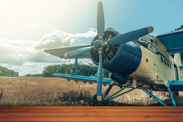 Red wooden table and beautiful airplane background.