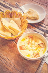Hummus Pureed chickpeas, tahini, lemon, garlic drizzled with extra virgin oil served with pita bread