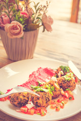 Green Pea Falafel Falafel ball served with tomato salsa and beetroot tahini puree