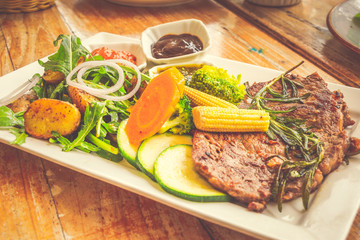 Prime Ribeye Steak 250 grams grilled prime ribeye steak served with rocket potato salad and mixed sauteed vegetables, pepper sauce