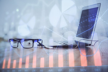 Forex Chart hologram on table with computer background. Multi exposure. Concept of financial markets.