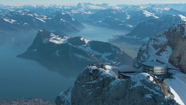 Mountain Pilatus Viewpoint, Lake and Lucerne City in Winter Morning. Tourists on Viewpoint. Swiss Alps, Switzerland. Aerial View. Drone is Orbiting