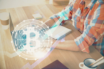 Blockchain theme hologram with man working on computer on background. Concept of crypto chain. Double exposure.