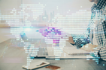 Multi exposure of businessman working on laptop on background. International business hologram in...