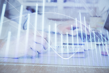 Multi exposure of financial graph with man works in office on background. Concept of analysis.