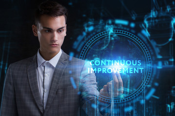 The concept of business, technology, the Internet and the network. A young entrepreneur working on a virtual screen of the future and sees the inscription: Continuous improvement