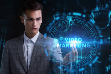 The concept of business, technology, the Internet and the network. A young entrepreneur working on a virtual screen of the future and sees the inscription: Video marketing