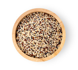 Pile of mixed raw quinoa in wood bowl isolated on white background. top view