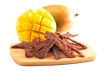 Gourmet Sweet Mango Flavored Beef Jerky on a Cutting Board