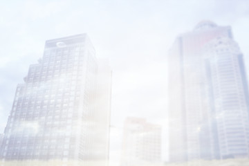Abstract Blurred background, Double exposure of business Skyscraper with sunrise and sky clouds, business and finance background concept