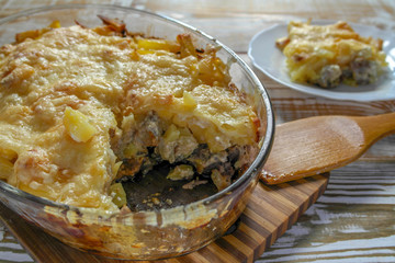 Ready meal - the Orlov-style meat with a piece cut off on a white plate. Freshly prepared dish with cut and close-up layers.