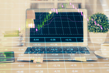 Financial graph colorful drawing and table with computer on background. Double exposure. Concept of international markets.