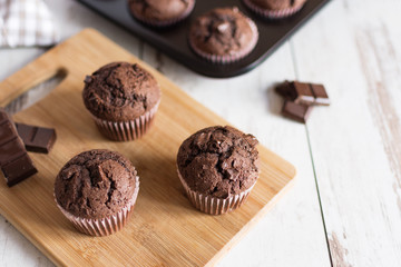 Just baked chocolate muffins with chocolate pieces.